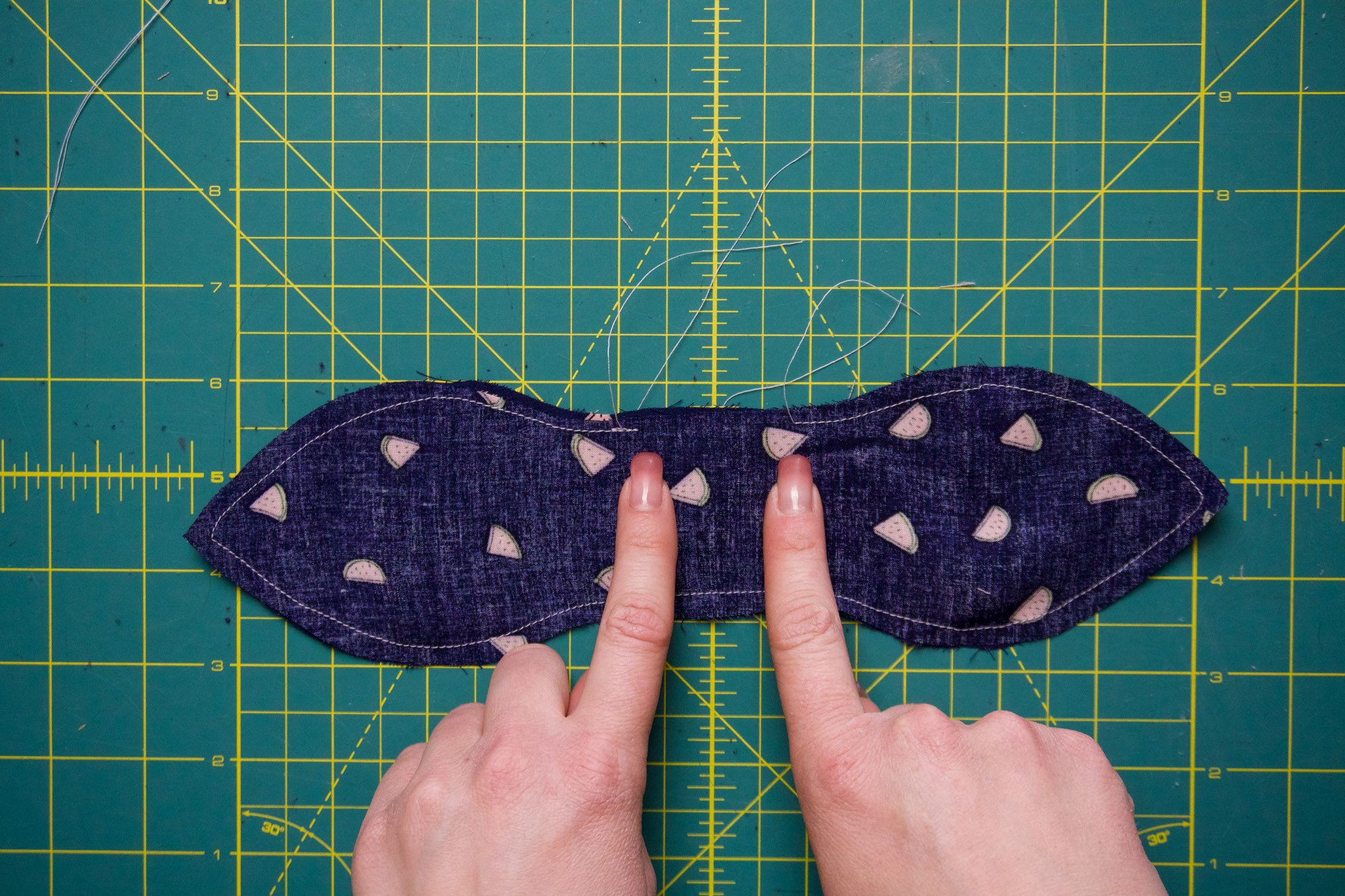 Sewn around the edge of the bow.